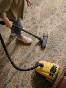 woman vacuuming rug