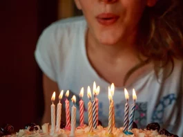 Woman blowing out birthday candles
