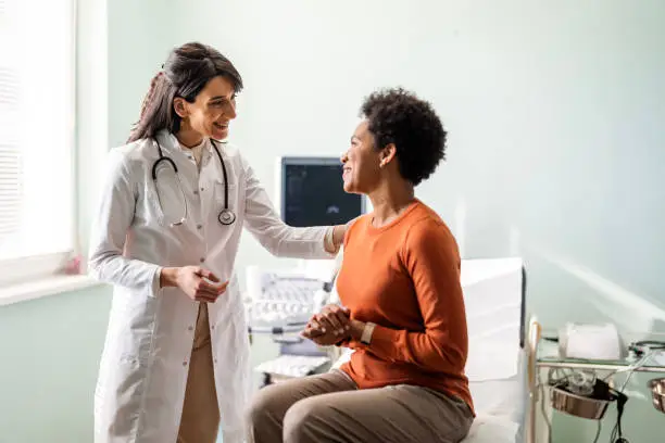 iStock photo - Female medical practitioner reassuring a patient stock photo The Confident Self-Advocate