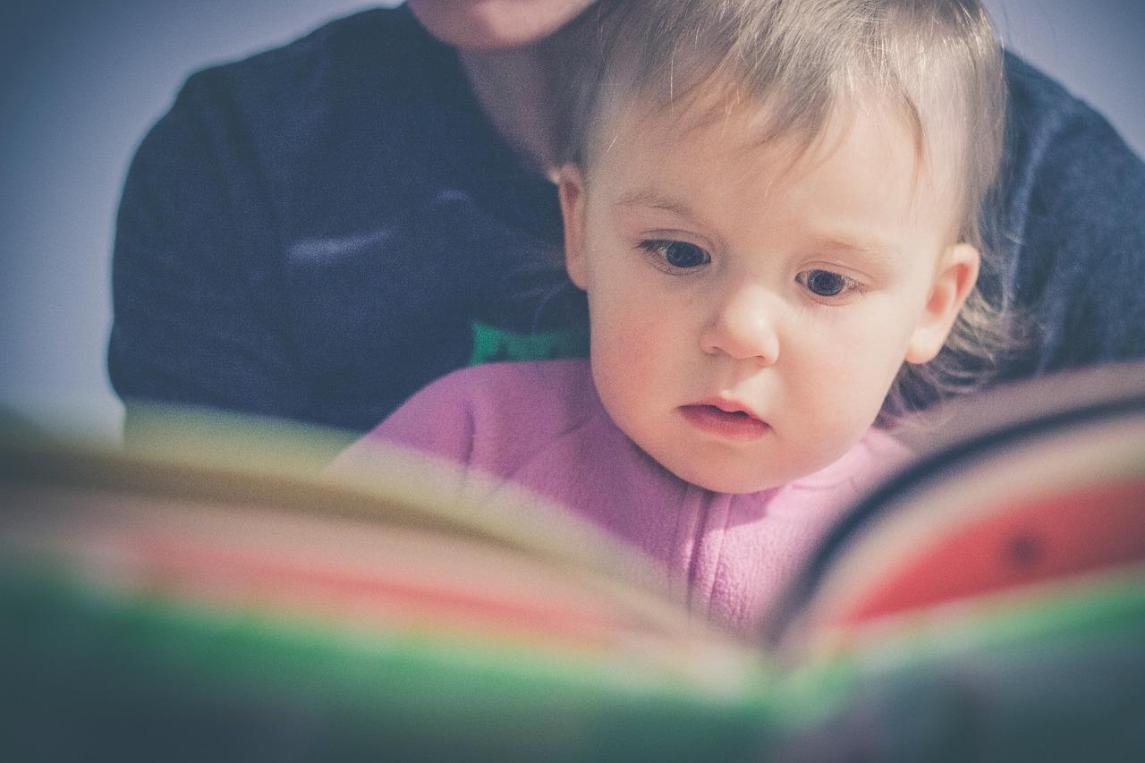 A child reading a book with their parent, Being A Good Mom Means Being A Regulated Mom